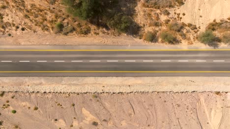 Empty-Desert-highway-mountain-road-with-Blue-cloudy-sky