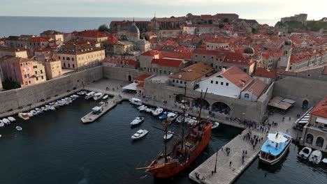 drone view featuring boats and motor boats docked at port in dubrovnik city of croatia. cityscape
