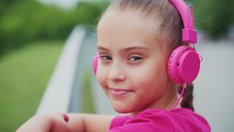 a young girl enjoying music with vibrant pink headphones, exuding confidence and joy in a serene outdoor setting, captured in two distinct frames
