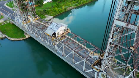 car drives over vertical lift bridge on welland canal in canada