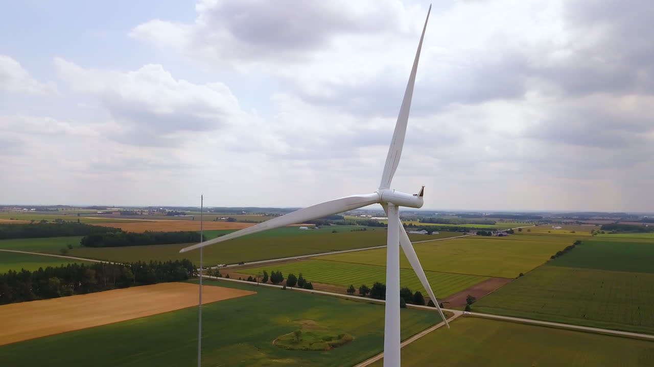 Aerial flying around the spinning blades of a wind turbine