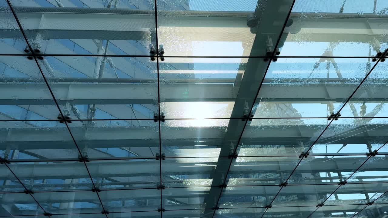 A clear glass ceiling structure with beams, sunlight shining through, Harumi, Tokyo