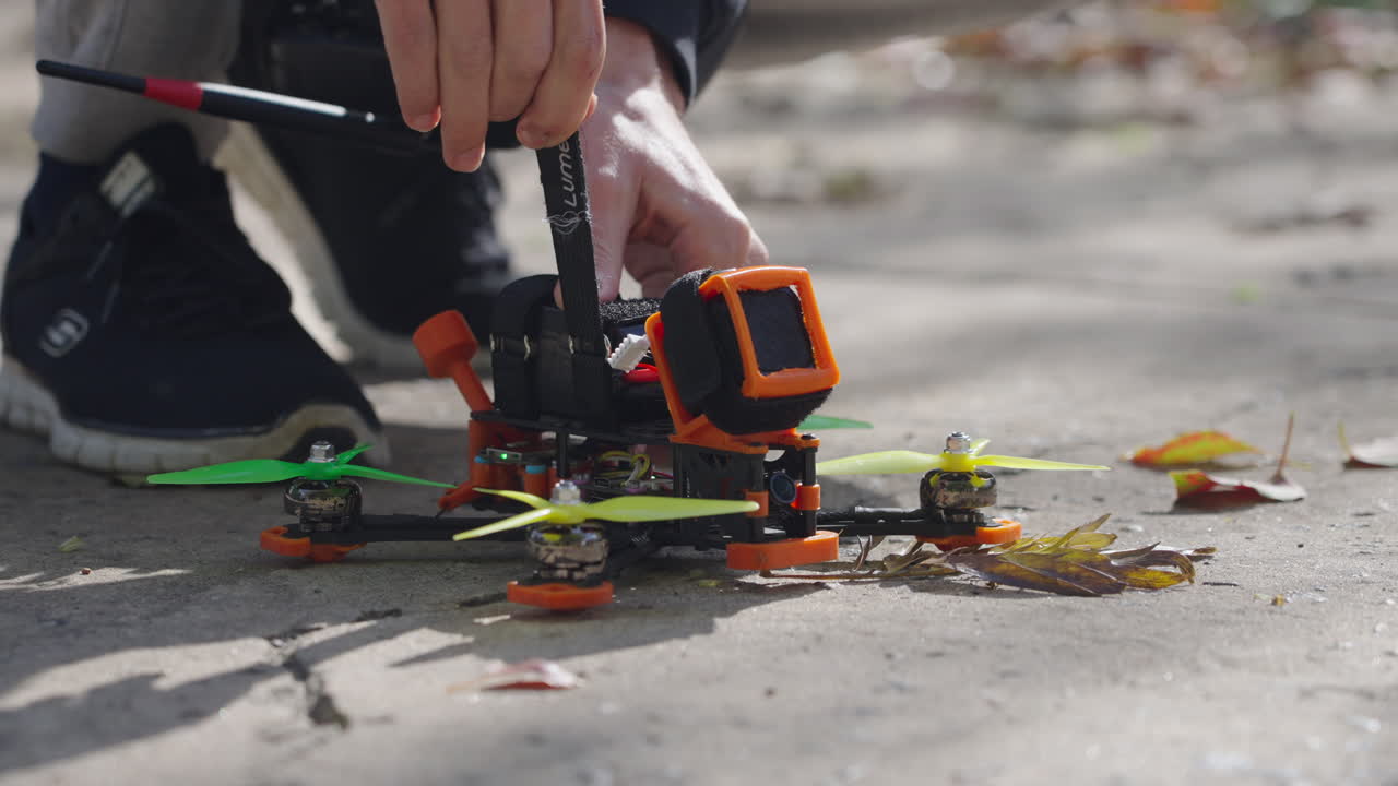 Close-up of Hands Connecting Battery to FPV Drone