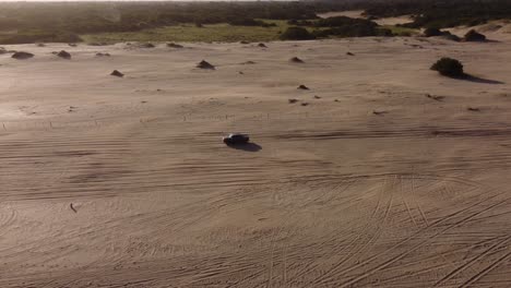 Four-wheel-vehicle-driving-on-beach-at-Mar-de-las-Pampas-in-Argentina