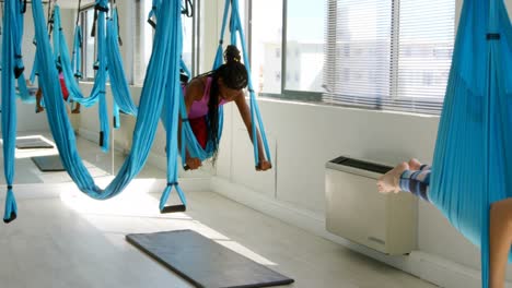 women doing yoga on hammock 4k