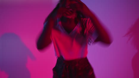 Studio-Shot-Of-Young-Woman-Dancer-Dancing-Against-Blue-And-Pink-Lit-Background-6