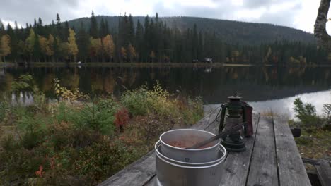 cooking food infront of a small lake with