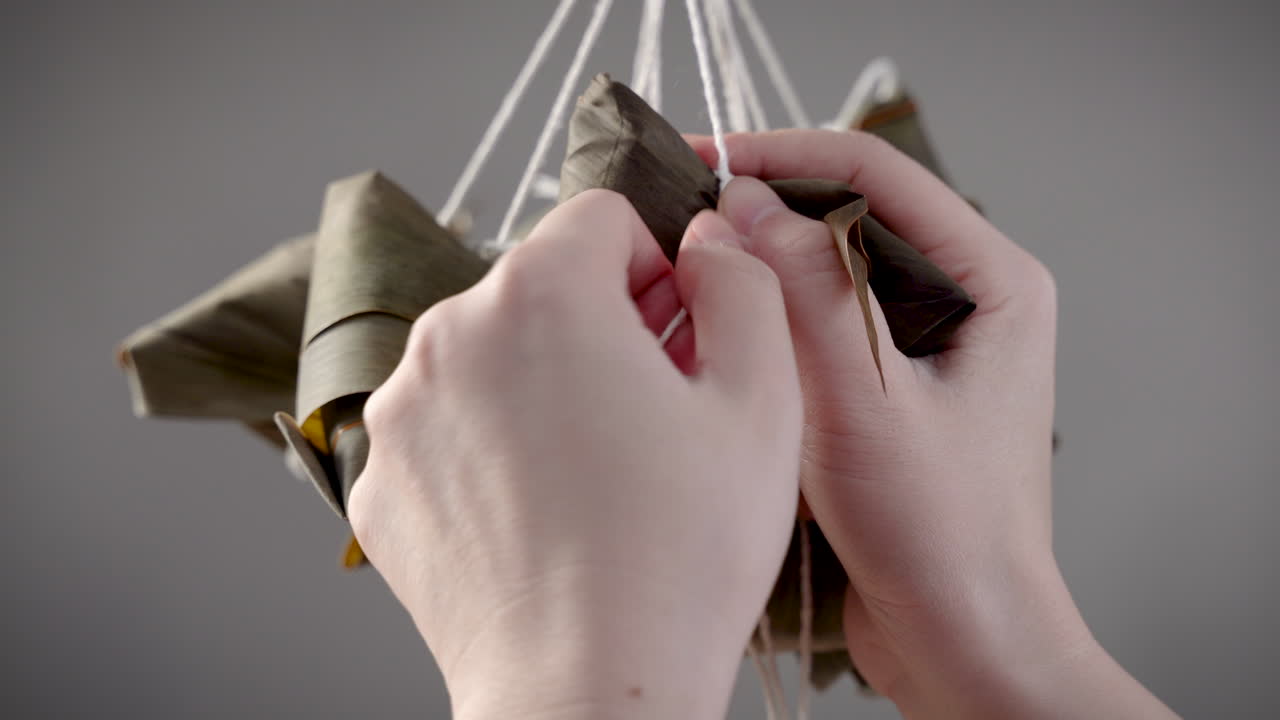 Making zongzi food - preparing and wrapping Chinese rice dumpling.