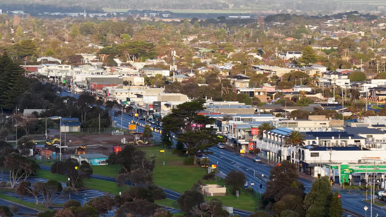 Aerial camera smoothly pans above Rye’s main street, revealing urban landscape and green spaces