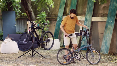 man ensuring bicycle function in yard