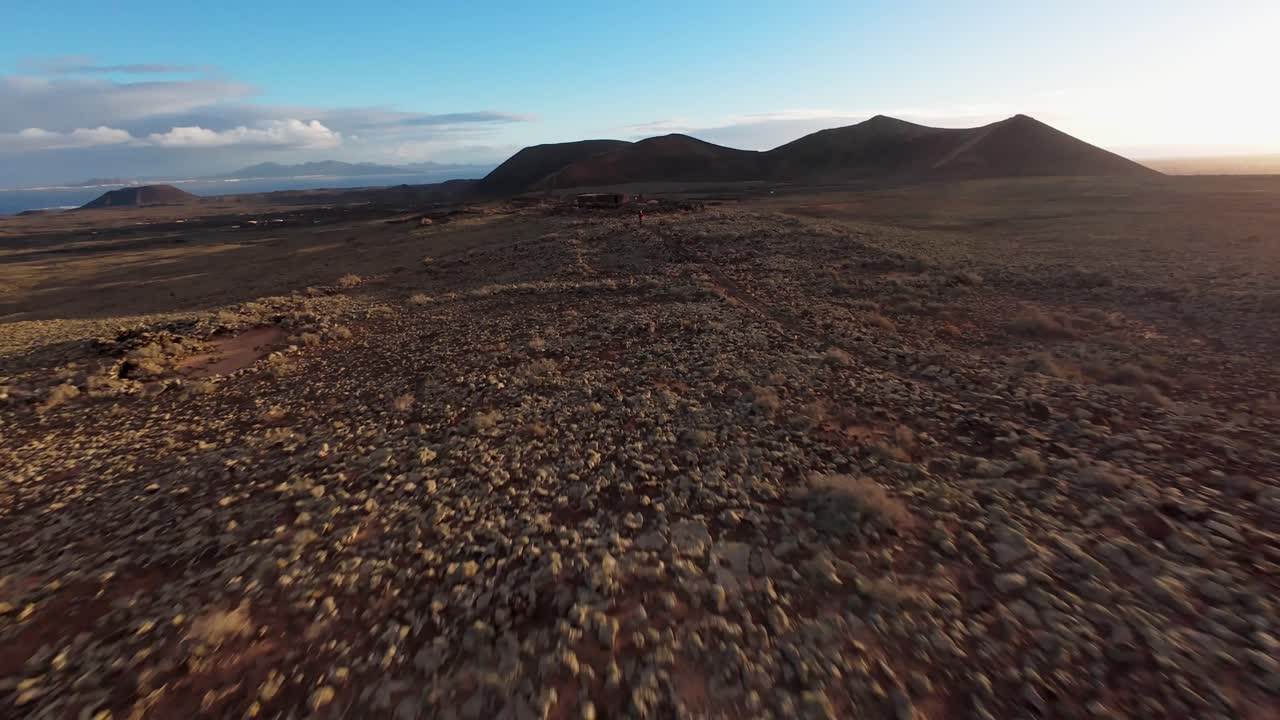 Una persona che cammina lungo sentieri nel terreno vulcanico di Calderón Hondo, vista aerea.