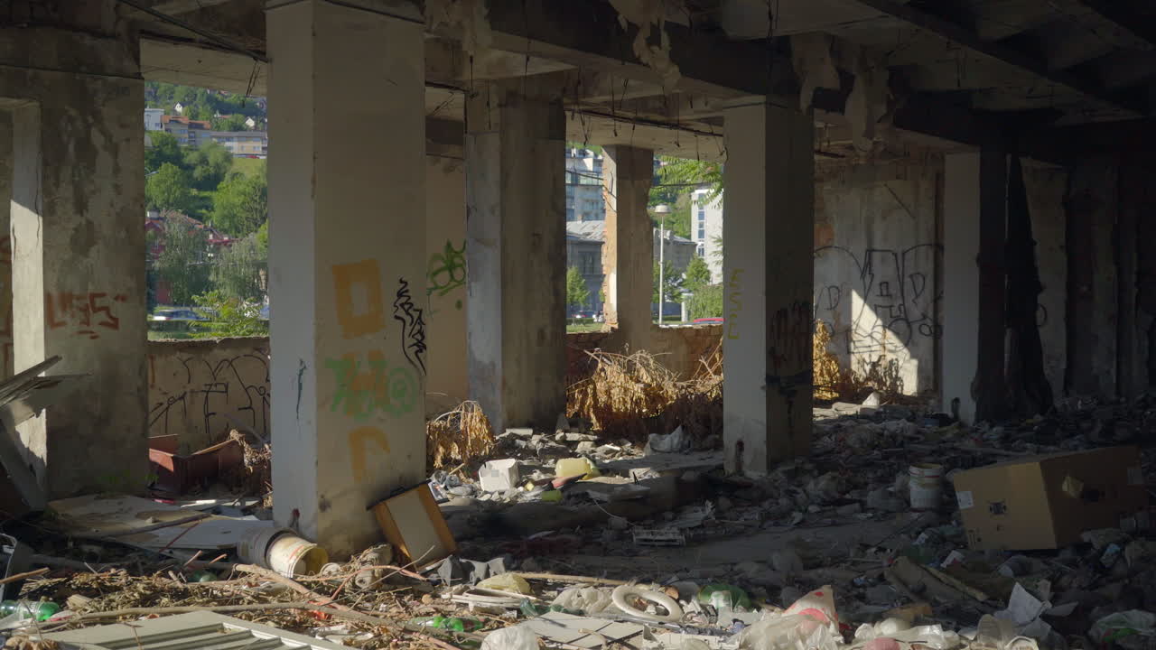 Foreground Wipe Reveal Interior of ruined building in Sarajevo, Bosnia with graffiti
