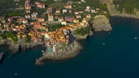 High-aerial-shot-of-of-beautiful,-colorful,-coastal,-Ligurian-village-of-Tellaro,-Italy