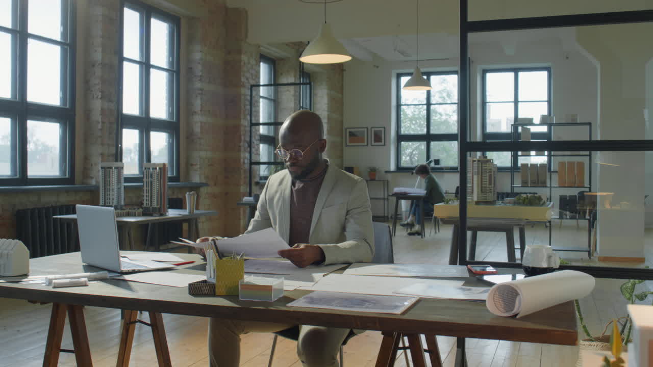 An architect working on designs in a modern office.