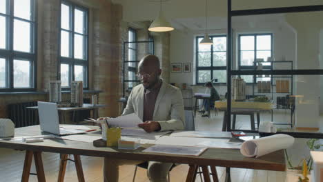 an architect working on designs in a modern office.