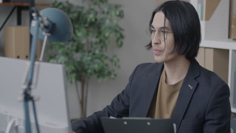 man working on computer in office