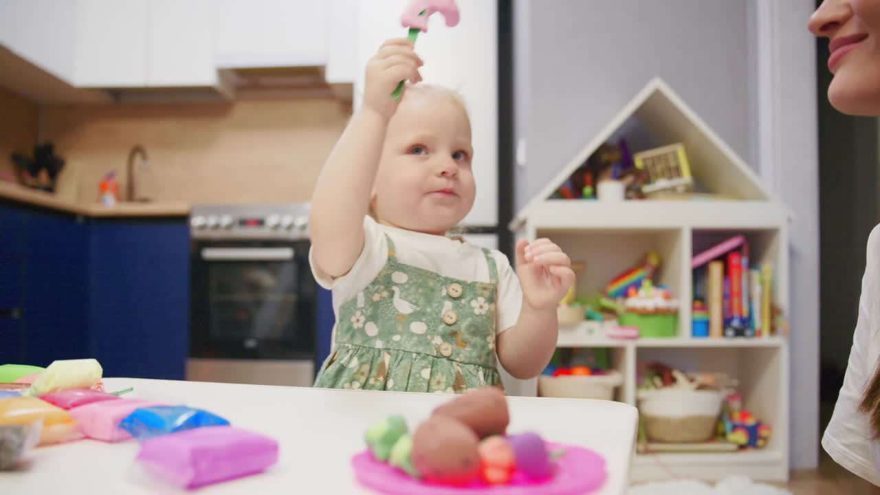 Cute Toddler Girl Playing with Colorful Playdough at Home