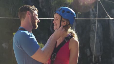 young caucasian couple in zip lining equipment