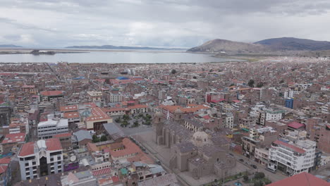 Drone shot above Plaza Mayor de Puno Peru near the church or cathedral LOG