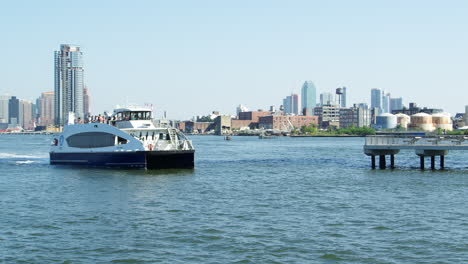 passenger ferry on hudson river in new york arriving at pier