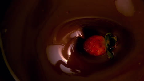 strawberries falling in melted chocolate