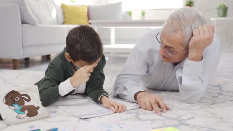 Happy-father-and-son-do-homework-at-home-and-get-along-well.