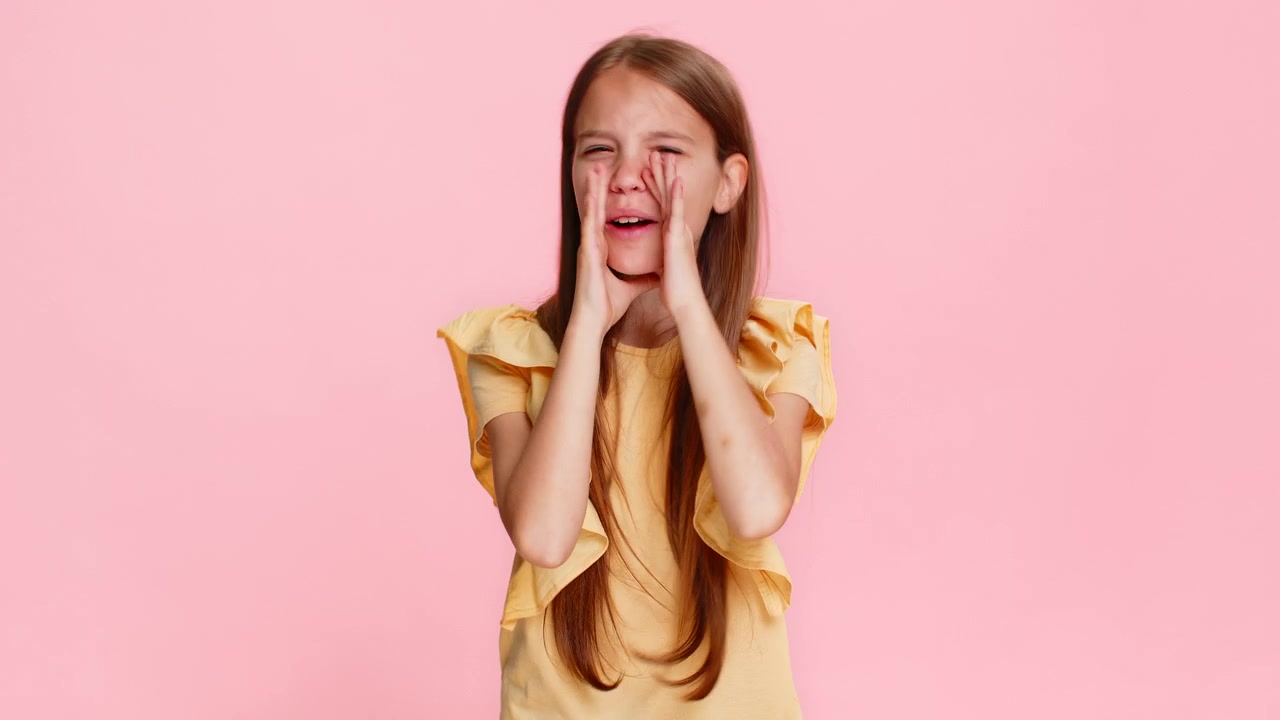 Child girl kid shouting with hands around mouth pretending to use loudspeaker to call someone loudly