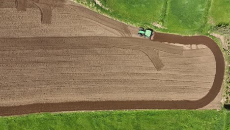 top view of a tractor working on fields at sao miguel, azores island, portugal