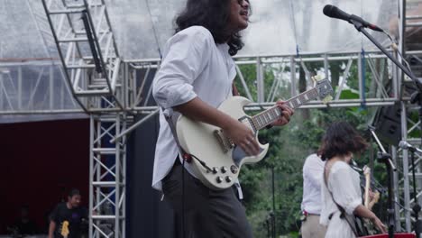 expressive guitarist at sunset di kebun concert in kebun raya bogor, singapore