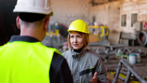 two co-workers talking at work