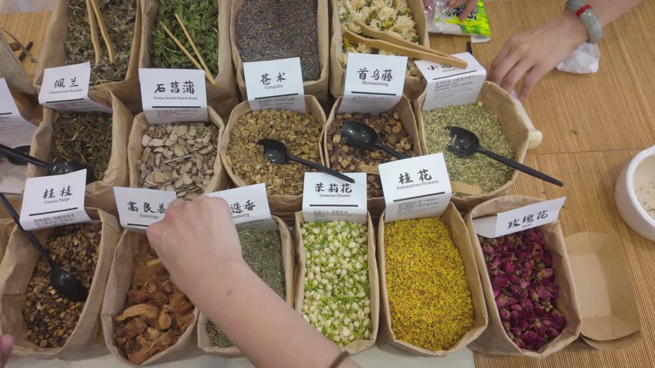 Watch the creative process of handpicking and grinding dried herbs and flowers to craft personalized aromatherapy sachets in a traditional setting