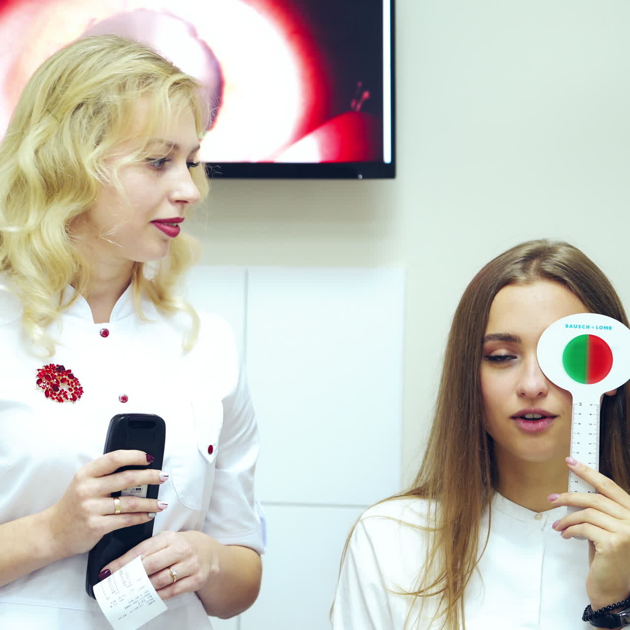 Doctor and patient checking eyesight. Front view of a woman doing vision test with one eye closed with occluder. Ophthalmological cabinet.