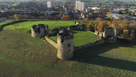 Historical-Flint-castle-medieval-military-ruins-landmark-aerial-view-rising-over-flight