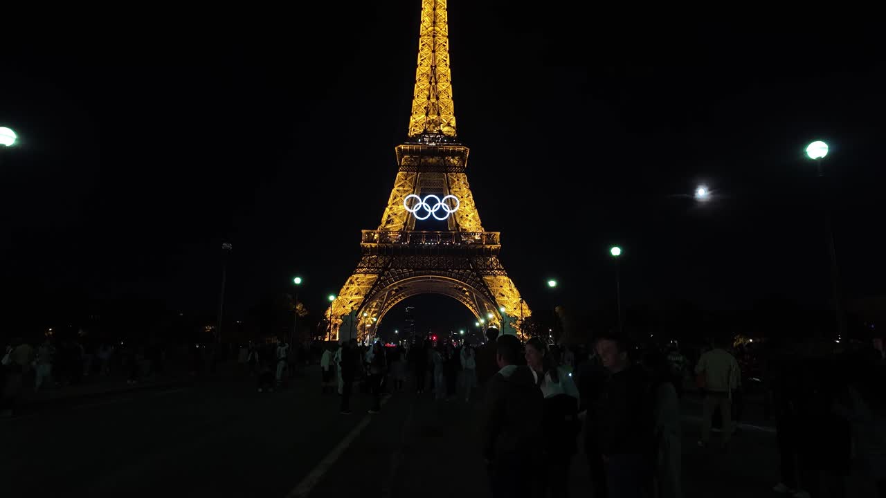Eiffel tower Olympic rings at night Paris France light up, tourist landmark
