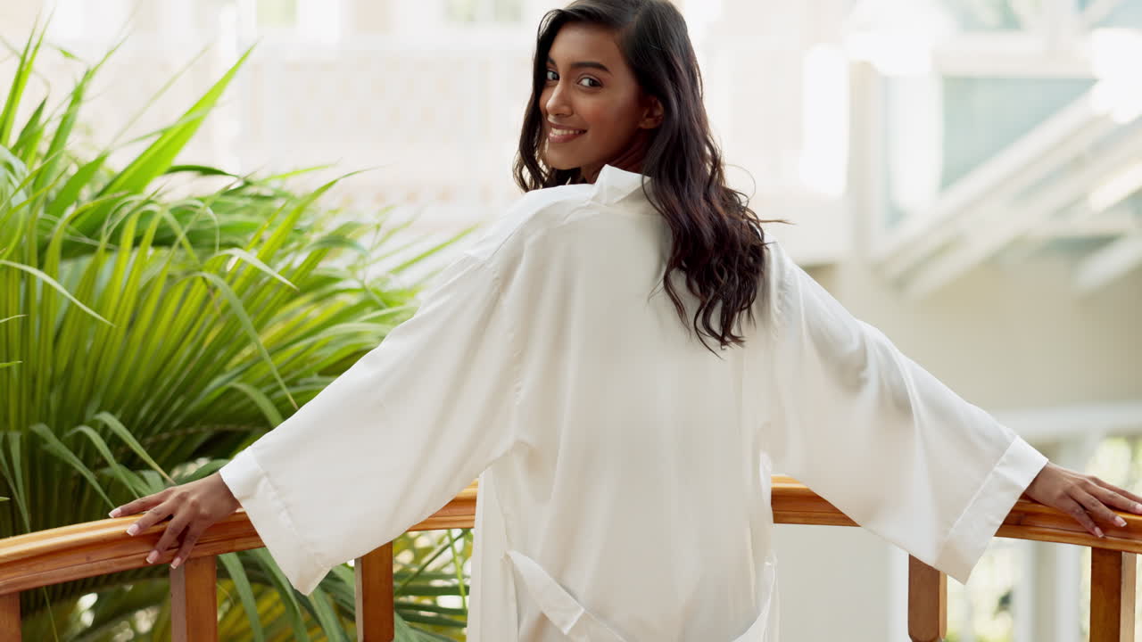 Woman in robe on balcony
