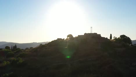 ancient fortress on hilltop at sunrise/sunset