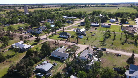 aerial view over broken houses in a village, tornado aftermath in kansas, usa