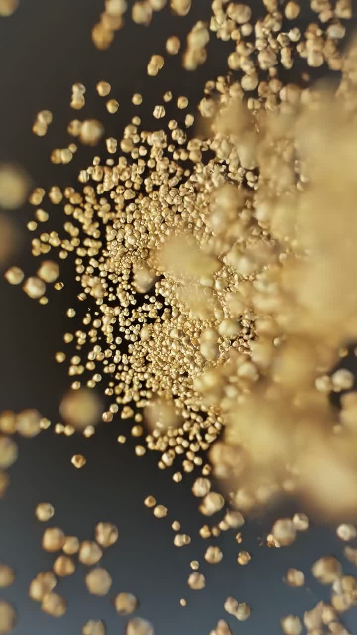 Dynamic sequence of golden particles suspended in motion against a dark background showcasing fluidity