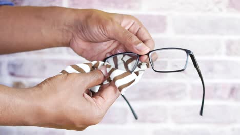 cleaning eyeglasses with a cloth