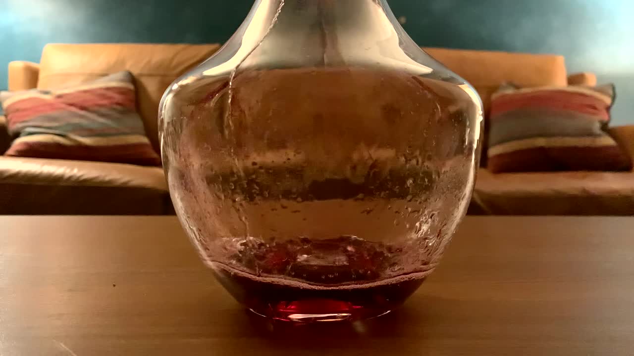 레드 와인을 물병에 천천히 붓습니다.