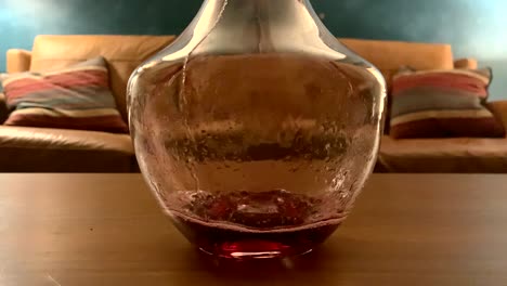 red wine slowly poured into carafe