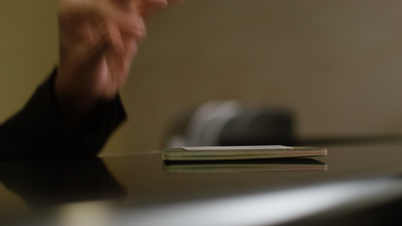Receptionist placing a passport and room key at the hotel reception desk