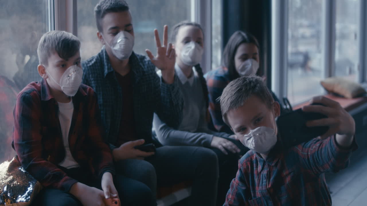 Teenagers Taking a Selfie While Wearing Masks