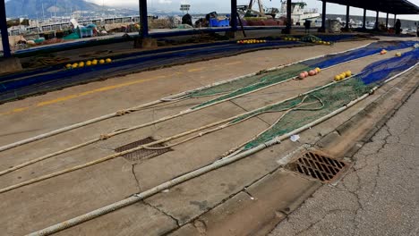 Tow-nets-lay-strewn-across-ground-by-the-pier-and-docks