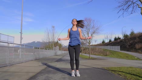 young attractive woman skipping outdoors wide shot real time