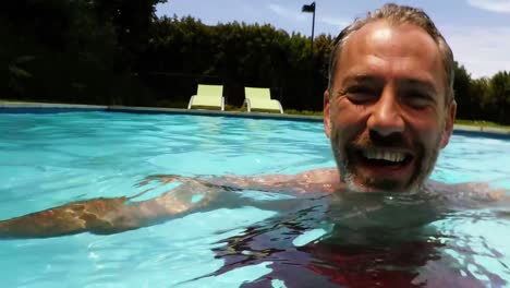 portrait of happy man swimming in pool