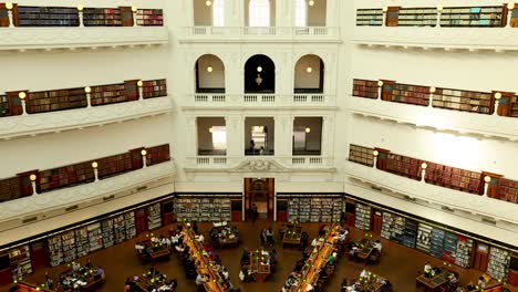 people reading in a grand library