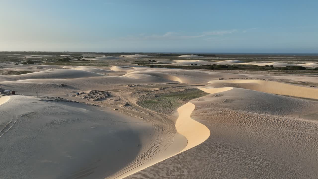 Flyover sand dunes and a small green vegetation patch at Lençóis Maranhenses National Park, Maranhão, Brazil