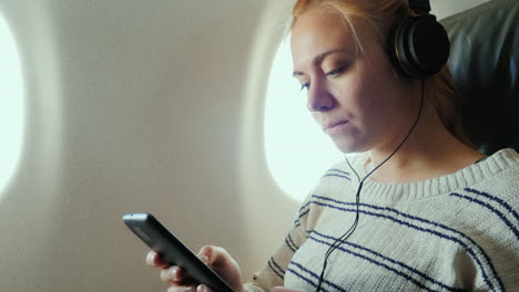 young attractive woman is flying in an airplane 2