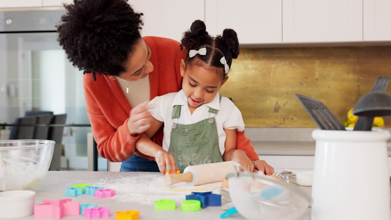 Mother, girl learning baking in kitchen